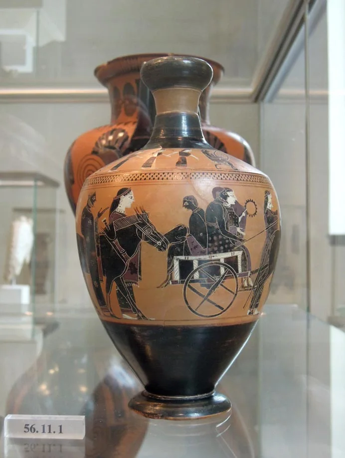 Black-figure oil flask: a bride and groom ride in a mule cart, with attendants walking beside it.
