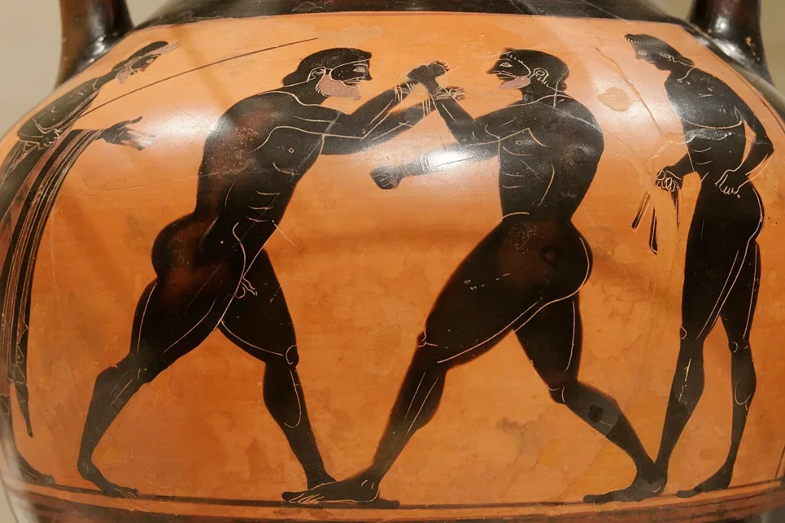 A black-figure vase: two boxers squaring up between two onlookers.