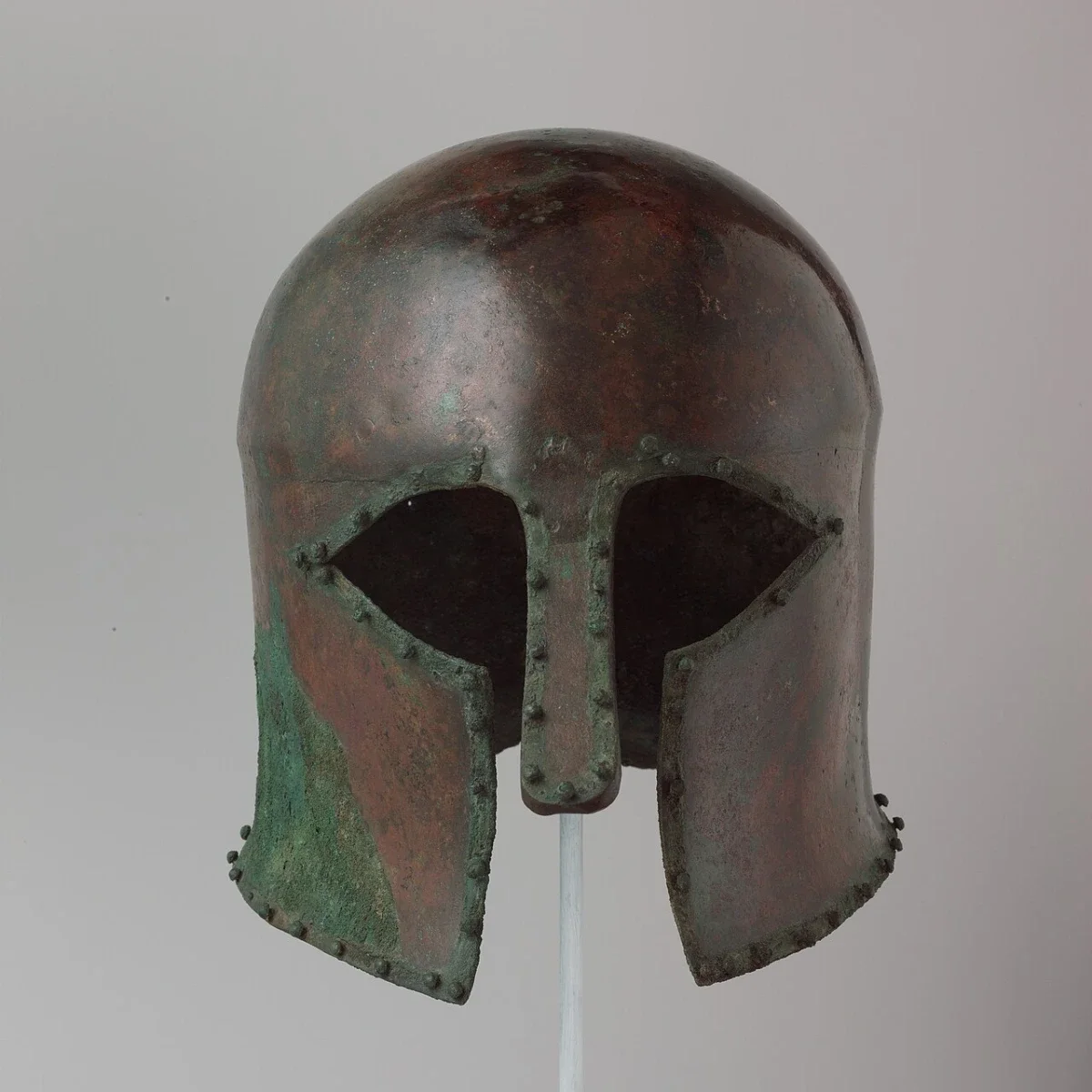 A bronze helmet covering the whole face, with eye openings and a nose guard.