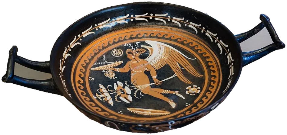 A red-figure cup seen from above: inside, a winged Eros flies holding a dish, a ball and a plant.