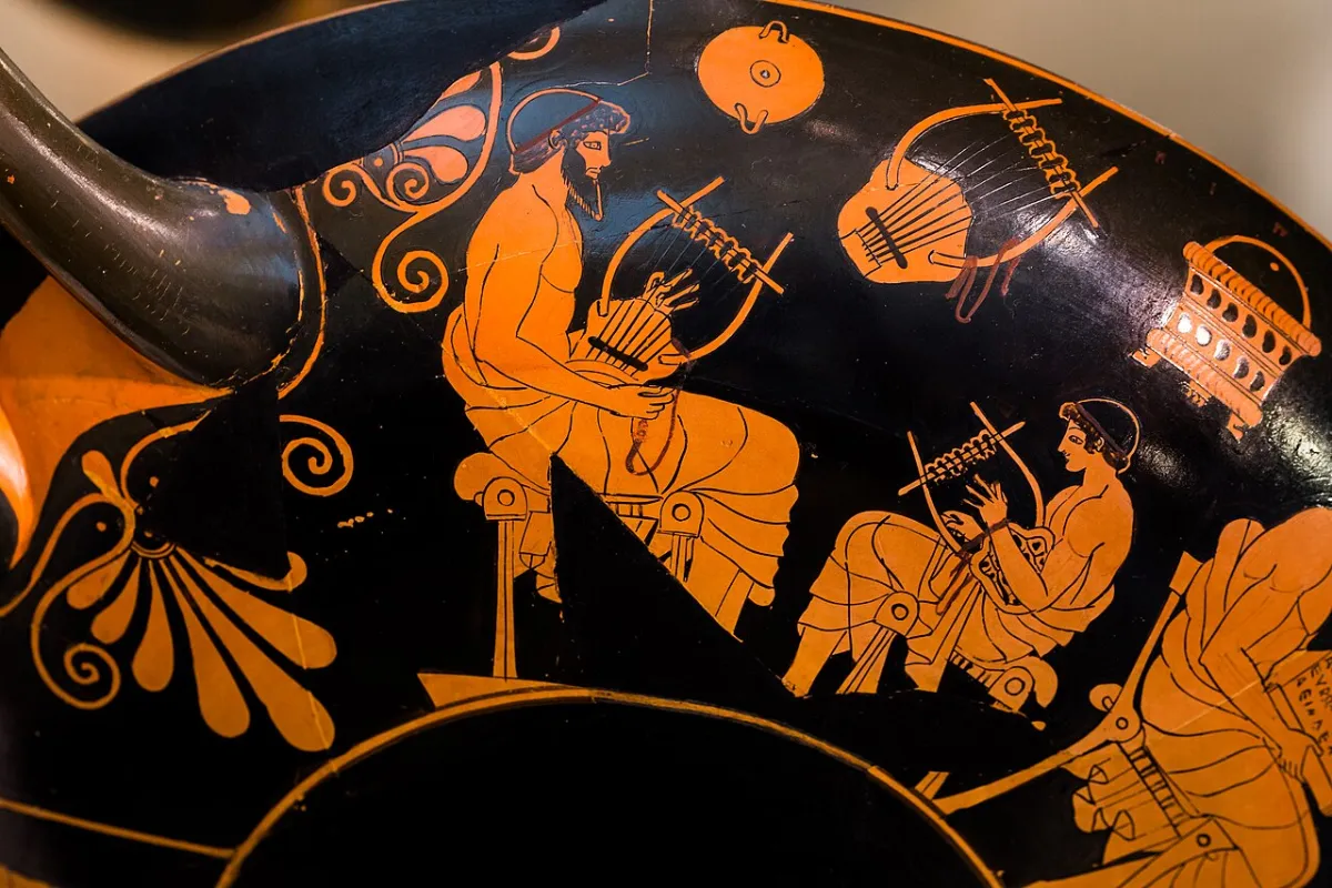 Red-figure vase painting: a bearded teacher and a boy, each seated with a lyre; more lyres hang on the wall.