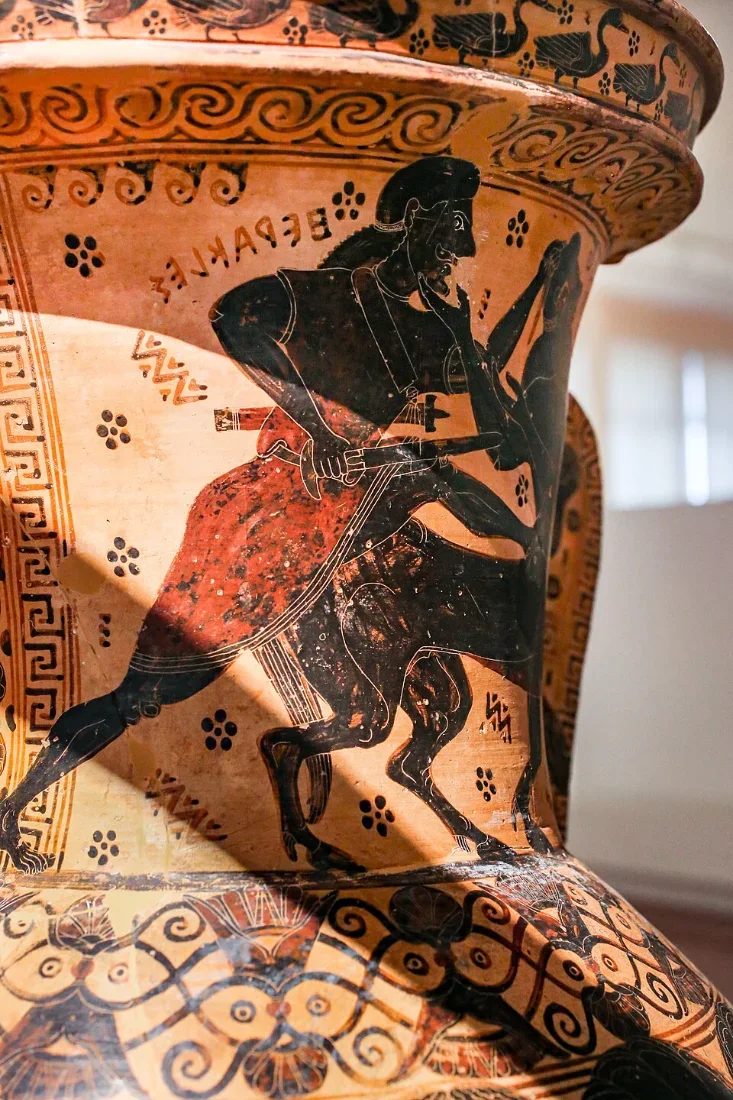 A large black-figure amphora neck: a hero grasps a centaur by the hair.