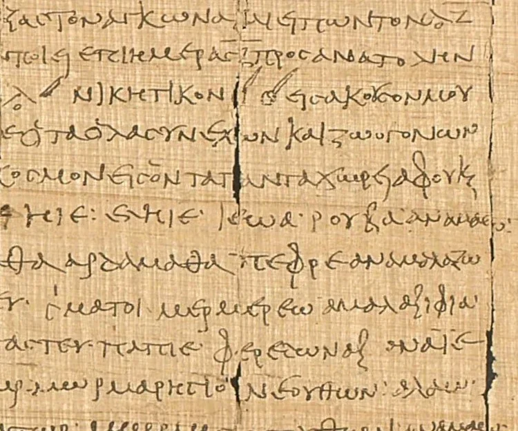A close view of a papyrus with lines of Greek handwriting.