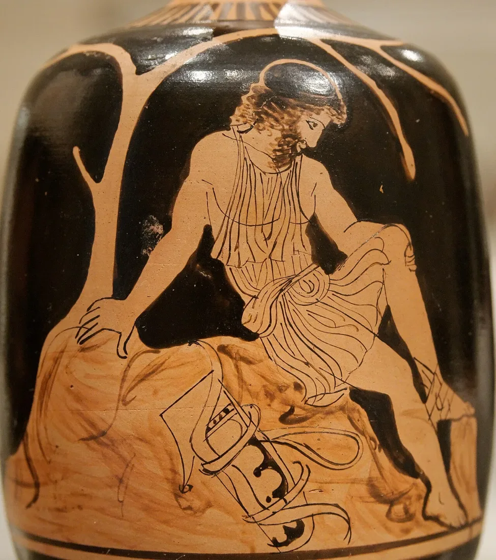 A red-figure vase: a young man sits on a rock, a bow beside him.