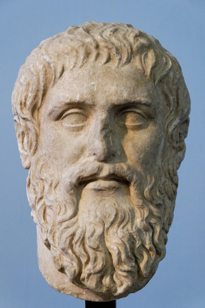 Marble portrait head of a bearded man with a lined forehead and thick wavy hair.