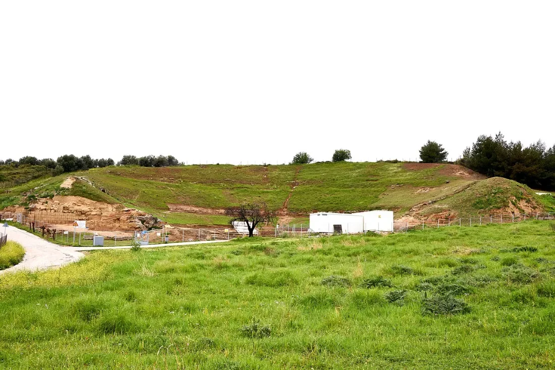 Grassy slopes of an excavated theatre in the countryside.