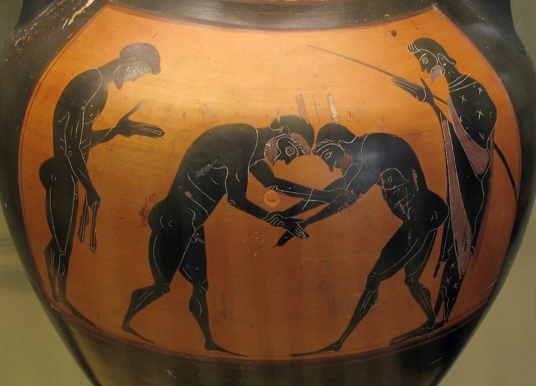 A black-figure amphora: two wrestlers grappling between two onlookers.